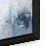 Close-up of a framed abstract wall art piece showcasing vibrant strokes in shades of blue, orange, and gold, perfect for modern home decor.