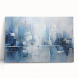 Abstract wall art featuring vibrant strokes in blue, orange, and yellow hues on a stretched canvas, elegantly leaning against a neutral wall, perfect for contemporary home decor.