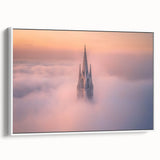 Framed canvas artwork showcasing a picturesque landscape of a medieval castle, elegantly displayed against a white wall, highlighting vibrant colors and intricate details.