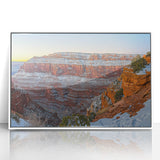 Framed acrylic art piece showcasing a stunning landscape of dramatic cliffs against a serene sky, presented in a sleek white frame, perfect for modern decor.