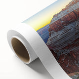 Vibrant rolled canvas showcasing a stunning landscape of cliffs at sunset, featuring warm hues of orange and red, ideal for home decor and artistic display.