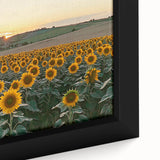 Framed canvas artwork depicting a serene countryside landscape with rolling hills, vibrant green fields, and a clear blue sky, ideal for home decor.