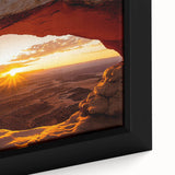 Close-up of a framed canvas artwork depicting a vibrant desert landscape with warm hues of orange and yellow, showcasing intricate details and textures, perfect for home decor.