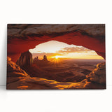 Desert landscape stretched canvas artwork showcasing vibrant orange and yellow hues with abstract mountain silhouettes, leaning against a textured wall. Ideal for modern home decor.