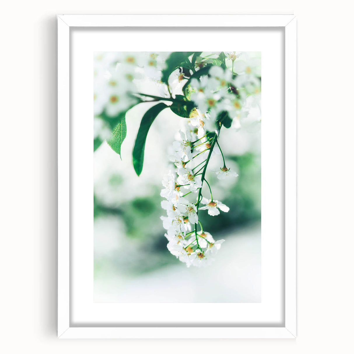 Abstract art print depicting spring with vibrant green and soft pink tones on a white framed canvas.