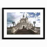 Black-framed landscape artwork showcasing a majestic castle surrounded by lush greenery, complemented by a white mat, ideal for home decor or gallery displays.