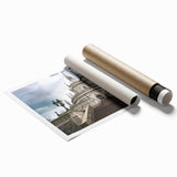 Rolled print showcasing a picturesque landscape featuring an elegant castle surrounded by lush greenery and serene blue skies, perfect for home decor.
