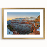 Elegant gold-framed landscape artwork depicting a dramatic cliff scene with vibrant colors, complemented by a white mat for a polished presentation, ideal for home decor.