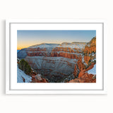 Framed landscape artwork depicting majestic cliffs, presented with a white mat, showcasing earthy tones and intricate details, perfect for home decor.