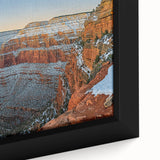 Close-up of a framed canvas artwork depicting dramatic landscapes with rugged cliffs and vibrant colors, ideal for adding an artistic touch to modern home decor.
