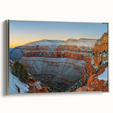Framed canvas artwork depicting a serene landscape of cliffs under a clear blue sky, showcasing intricate details and a silver frame, perfect for modern home decor.