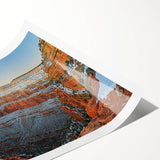 Vibrant rolled print of a striking landscape featuring dramatic cliffs and serene ocean waves, perfect for home decor or office aesthetics.