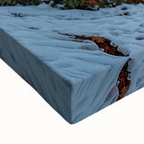 Close-up of a vibrant stretched canvas artwork depicting dramatic cliffs and serene landscapes, showcasing rich colors and intricate textures that enhance wall decor.