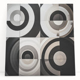 Abstract geometric stretched canvas artwork featuring vibrant colors and sharp angles, leaning against a neutral-toned wall, perfect for modern home decor.