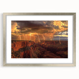 Framed landscape artwork showcasing vibrant canyons in rich earthy tones, set in a sleek silver frame with a mat, perfect for enhancing modern decor.