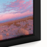 Close-up of a framed canvas artwork depicting a vibrant desert landscape, showcasing rich colors of orange and gold, ideal for home decor and nature enthusiasts.