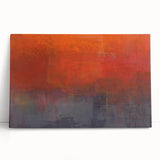 Abstract wall art featuring vibrant strokes in shades of blue, pink, and gold on a stretched canvas, leaning against a neutral wall, perfect for modern decor.