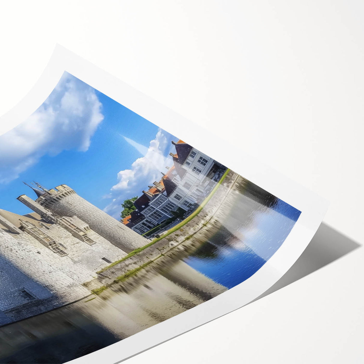 Rolled canvas print showcasing a vibrant landscape featuring a majestic castle surrounded by lush greenery and a serene blue sky, elegantly packaged in a protective tube for easy transport and display.