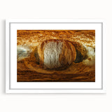 Framed landscape artwork depicting intricate cave formations in earthy tones, set against a white mat background, ideal for home decor or art displays.
