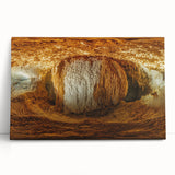 Stretched canvas artwork depicting a serene landscape with caves, featuring earthy tones and intricate details, ideal for home or office decor.