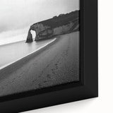 Close-up of a framed canvas depicting dramatic cliffs and serene landscapes, showcasing vibrant colors and intricate details, perfect for enhancing home decor.