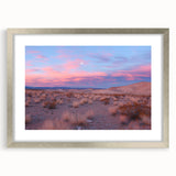 Framed desert landscape artwork with a silver mat, showcasing vibrant hues of orange and gold, ideal for modern home decor or office aesthetic.