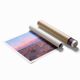 Desert landscape art print rolled and packaged in a protective tube, showcasing warm earthy tones and intricate details of arid terrain, perfect for home decor.