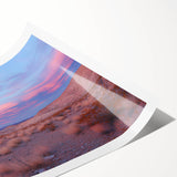 Desert landscape rolled canvas print showcasing vibrant hues of orange and yellow under a clear blue sky, elegantly packaged in a protective tube for shipping. Ideal for home decor enthusiasts seeking a warm, serene ambiance.