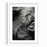 Abstract art print featuring swirling blue and gray patterns on a white framed canvas.