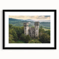 Black framed landscape artwork showcasing a majestic castle surrounded by serene nature, complete with a white mat for an elegant finish. Perfect for home decor.