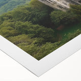 Stunning rolled canvas artwork depicting a vibrant landscape with a majestic castle surrounded by lush greenery, elegantly packaged in a protective cardboard tube. Perfect for home decor enthusiasts seeking unique wall art.