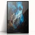 Framed acrylic artwork depicting a stunning landscape with caves, featuring a sleek black frame and clear glass front, ideal for modern home decor.