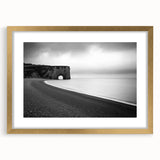 Elegant gold-framed landscape artwork showcasing dramatic cliffs and serene scenery, enhanced with a white mat for a sophisticated finish, perfect for home decor.