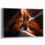 Framed canvas artwork depicting a stunning landscape of canyons, showcasing vibrant colors and intricate details, highlighted by a sleek silver frame, perfect for home decor.