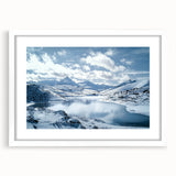 Framed landscape artwork showcasing a serene countryside scene with vibrant greens and blues, set in a white mat for an elegant display. Perfect for home decor.