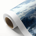 Vibrant rolled canvas artwork showcasing a serene countryside landscape with rolling hills and a clear blue sky, elegantly packaged in a protective cardboard tube.