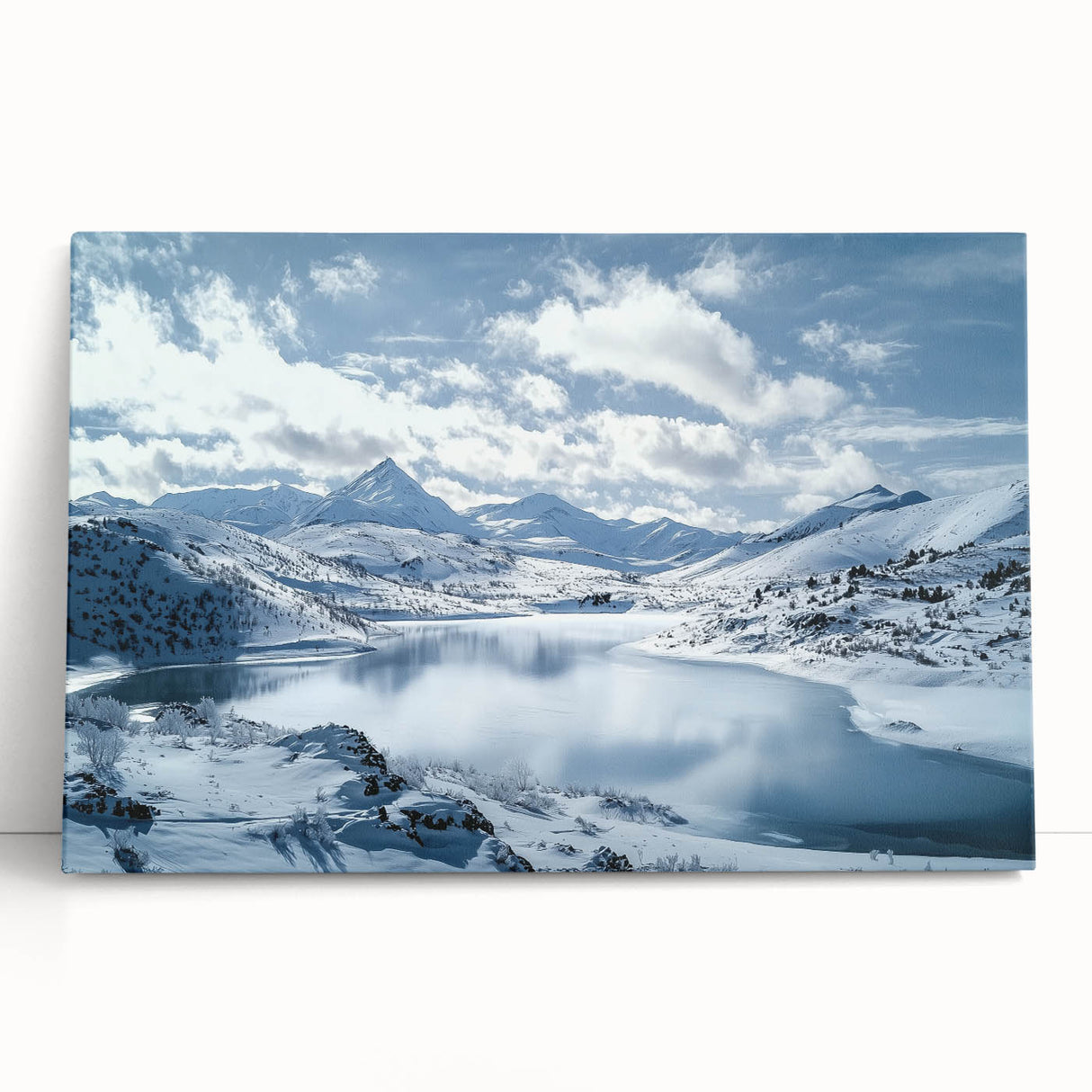 Stretched canvas art depicting a serene countryside landscape with rolling hills and a vibrant blue sky, leaning against a rustic wall, ideal for home decor.