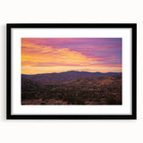 Black-framed landscape artwork of a serene desert scene, featuring soft sand dunes and a vibrant sunset, ideal for modern home decor.