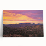 Stretched canvas art depicting a vibrant desert landscape with warm hues of orange and yellow, leaning against a textured wall, enhancing modern home decor.