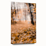 Large abstract wall art on acrylic glass depicting autumnal trees in orange and red hues, ideal for dining room decor.