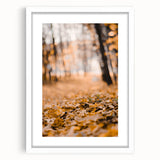 Abstract art print featuring swirling autumnal hues on a white framed canvas, suitable for dining room or bedroom decor.