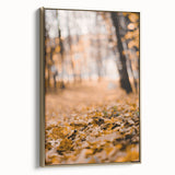 Framed canvas featuring a vintage-style landscape painting with autumnal trees in muted gold and black tones.