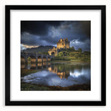 Elegant black-framed landscape artwork showcasing a majestic castle surrounded by lush greenery, featuring a white mat for a polished presentation. Perfect for home decor.