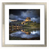 Elegant silver-framed landscape print featuring a majestic castle surrounded by lush greenery, showcased with a white mat for a refined presentation.