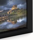 Close-up of a framed canvas print depicting a majestic castle landscape surrounded by lush greenery, showcasing vivid colors and intricate details in the artwork.