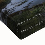 Close-up of a stretched canvas depicting a vibrant landscape with an intricate castle, showcasing rich colors and fine details, perfect for interior decor.