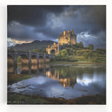 Stretched canvas artwork depicting a vibrant landscape with a majestic castle surrounded by lush greenery and a clear blue sky, ideal for home decor.