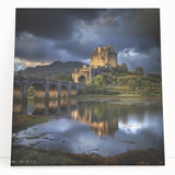 Stretched canvas artwork depicting a scenic landscape with a majestic castle surrounded by vibrant greenery and a serene blue sky, perfect for home decor.