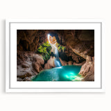 Framed landscape artwork showcasing a serene cave scene with vibrant colors, set against a white mat background, ideal for home decor or office enhancement.