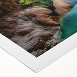 Vibrant rolled canvas artwork depicting a stunning landscape scene with caves, featuring rich colors and detailed textures, elegantly packaged in a protective cardboard tube for safe storage and display.